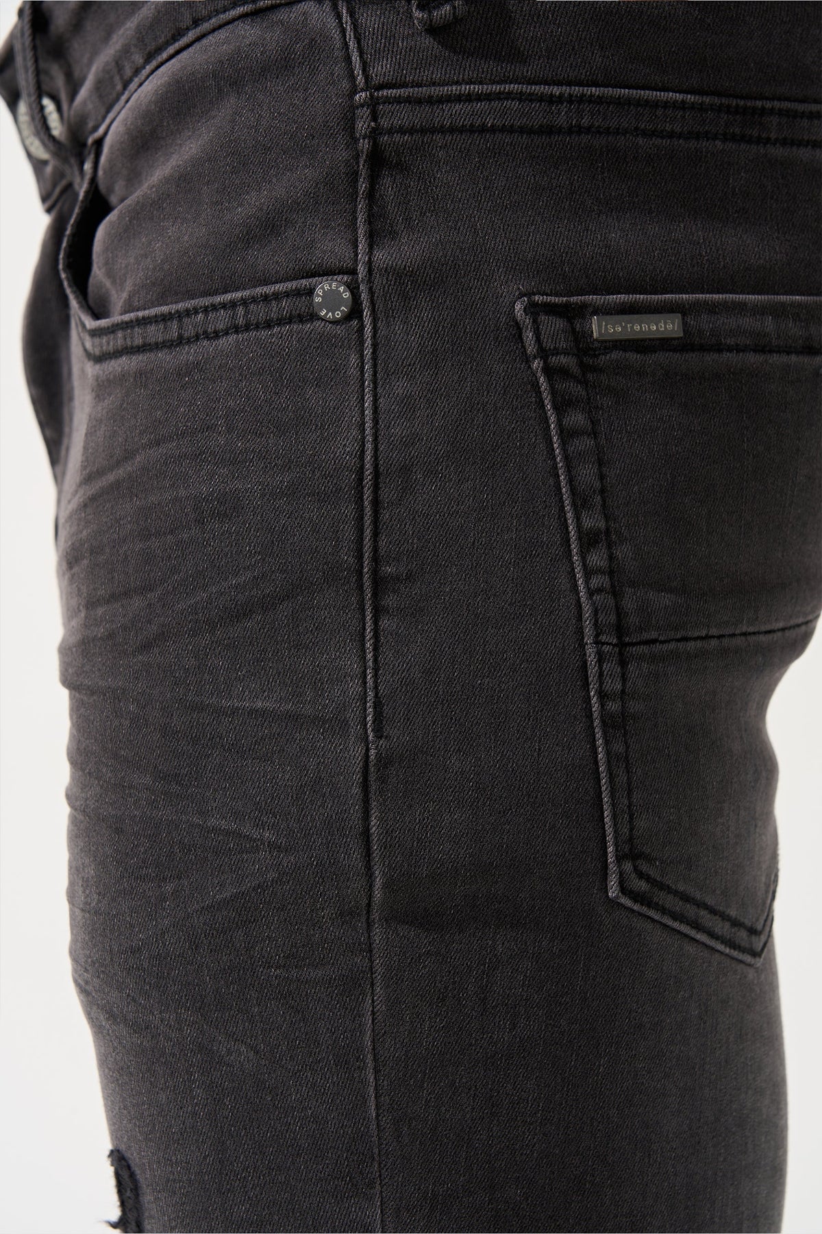 Men's charcoal jeans close-up of waistband, belt loop, and right pocket
