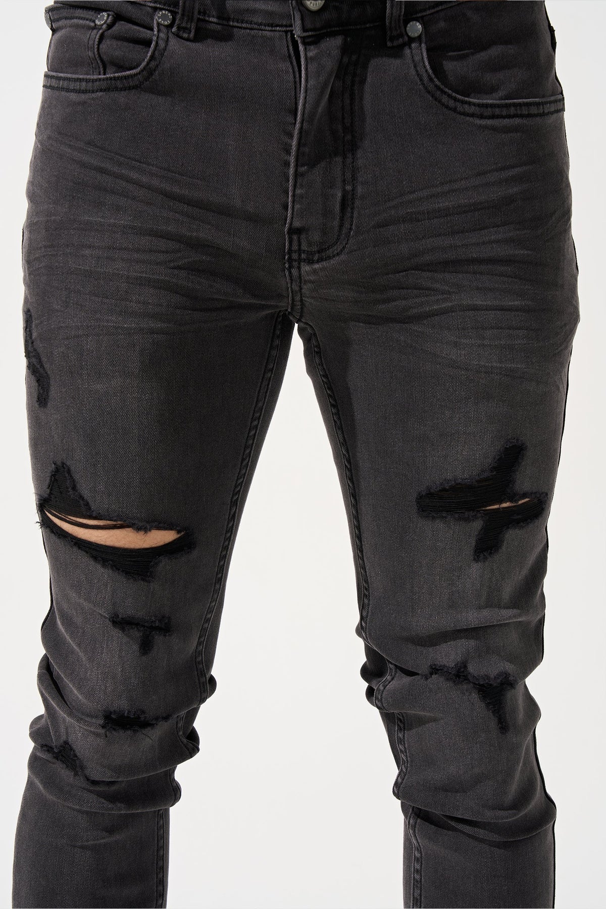 Men's charcoal jeans close-up with belt loops, button fly, and thigh rips