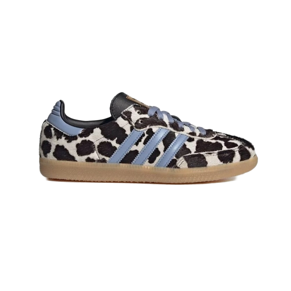 Cow-print low-top sneakers with light blue stripes, black heel, lace-up, gum sole