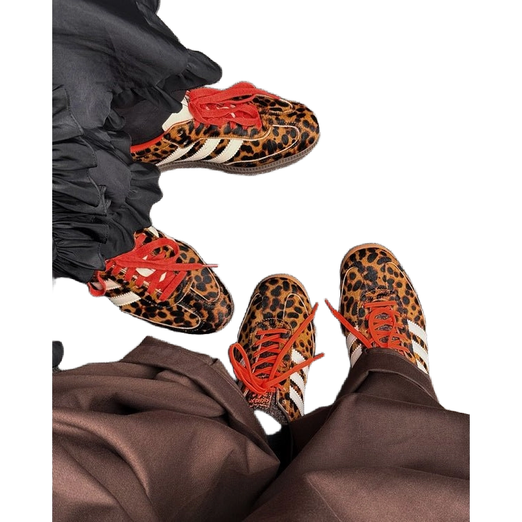 Adidas Samba OG leopard-print sneakers with red laces on feet, black pants visible