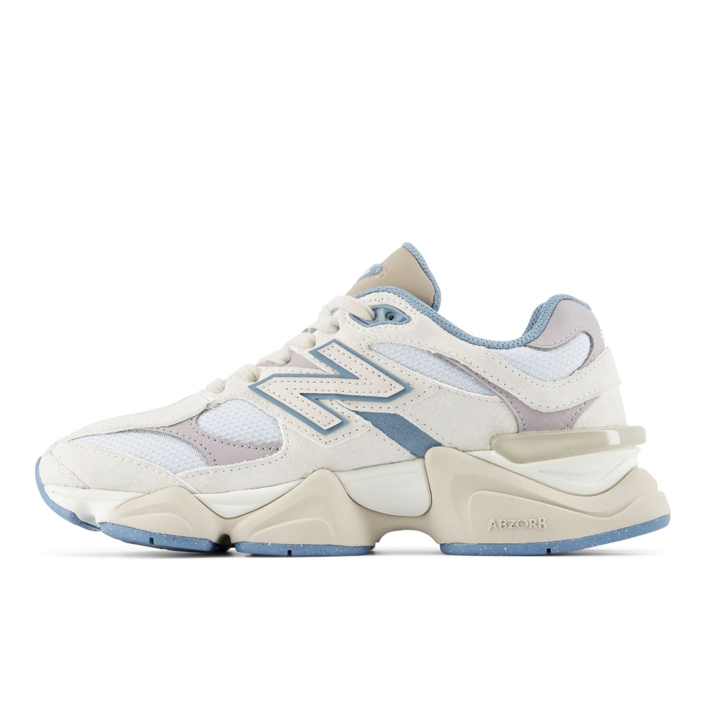 Sneaker side view with blue toe, beige overlays, and thick cushioned sole