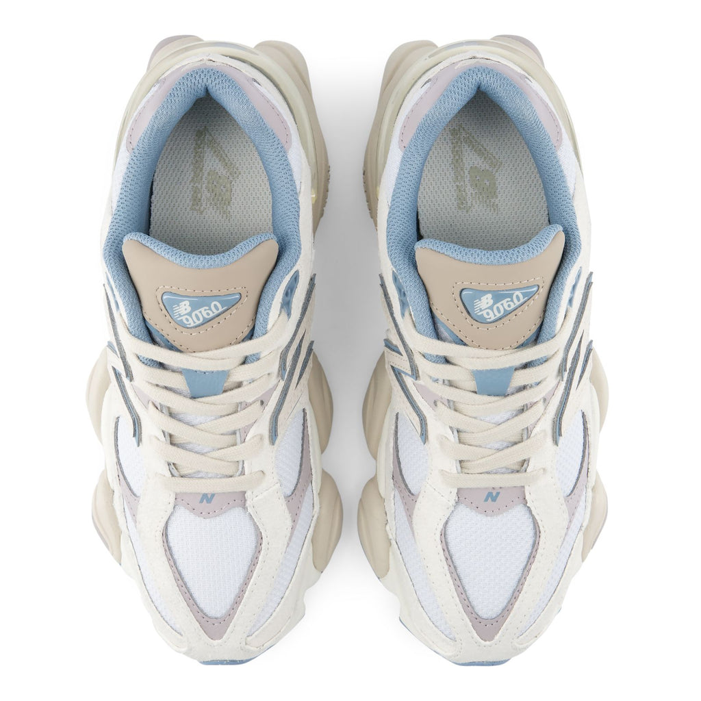 Pair of lace-up sneakers showing blue insoles and New Balance tongue branding