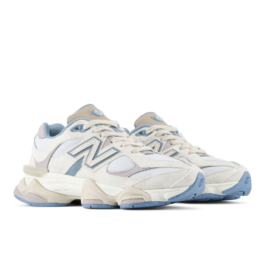 Lace-up sneakers with blue accents, cream midsole, and layered design