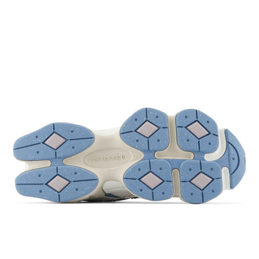 Outsole view with blue traction rubber pods and beige midfoot