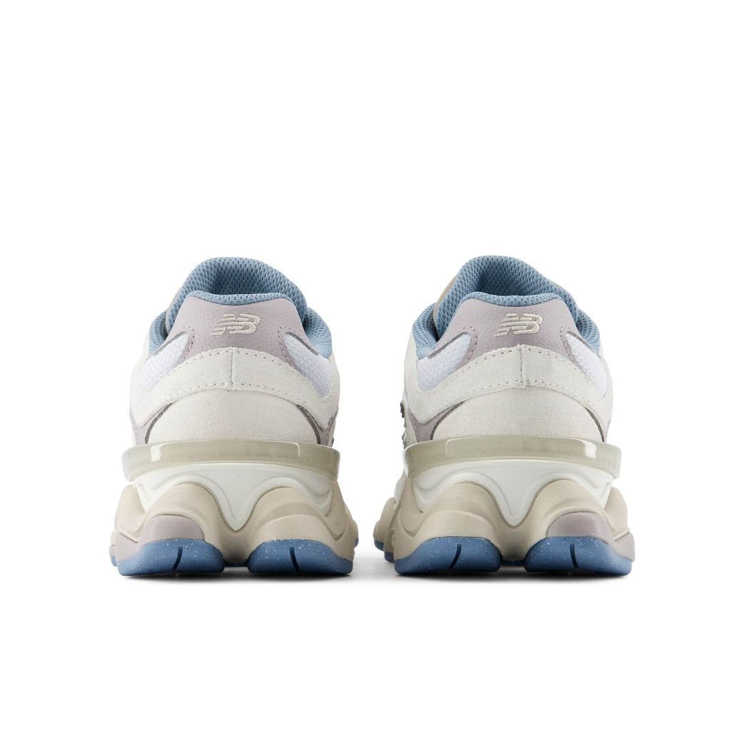 Heel view of lace-up sneakers with blue heel tabs, beige uppers, and chunky sole