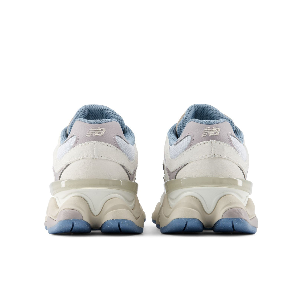 Heel view of lace-up sneakers with blue heel tabs, beige uppers, and chunky sole