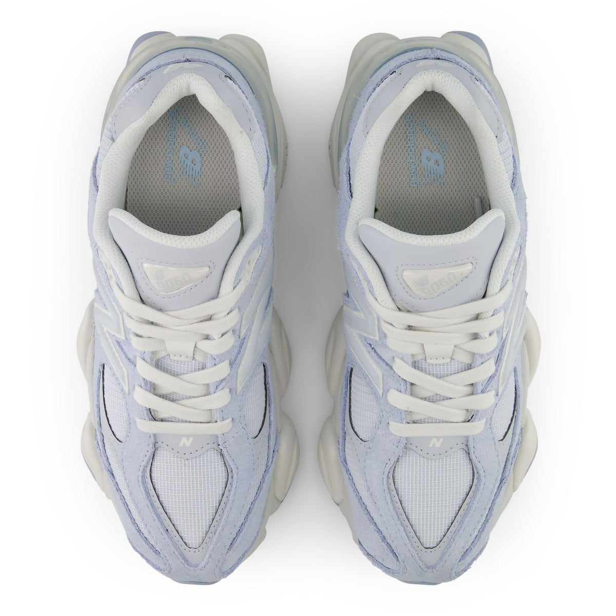 Pair of light indigo lace-up sneakers showing inner lining and cushioned padded collars