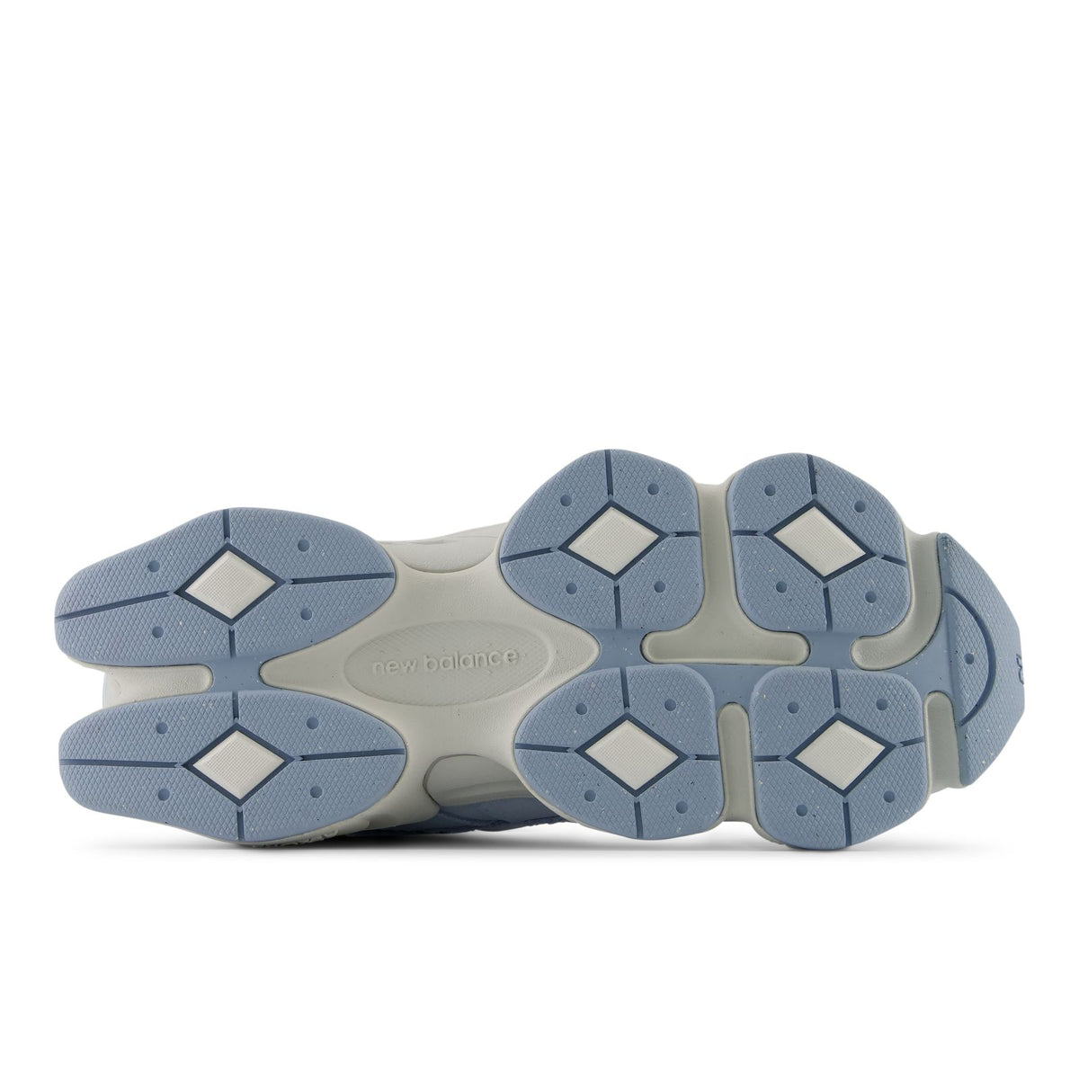 Light indigo sneaker outsoles with hexagonal traction pods and beige midfoot support