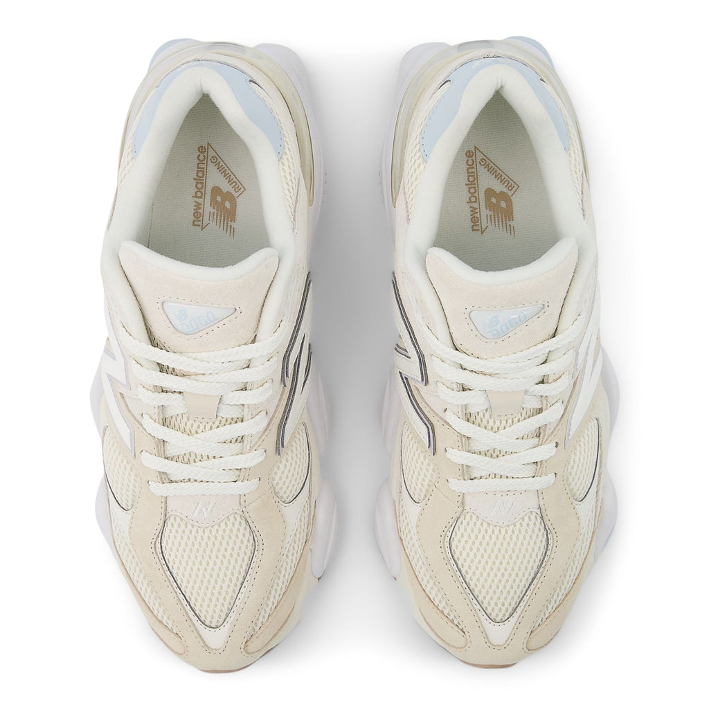 New Balance 9060 shoes top view in bisque with white laces and blue logo accents