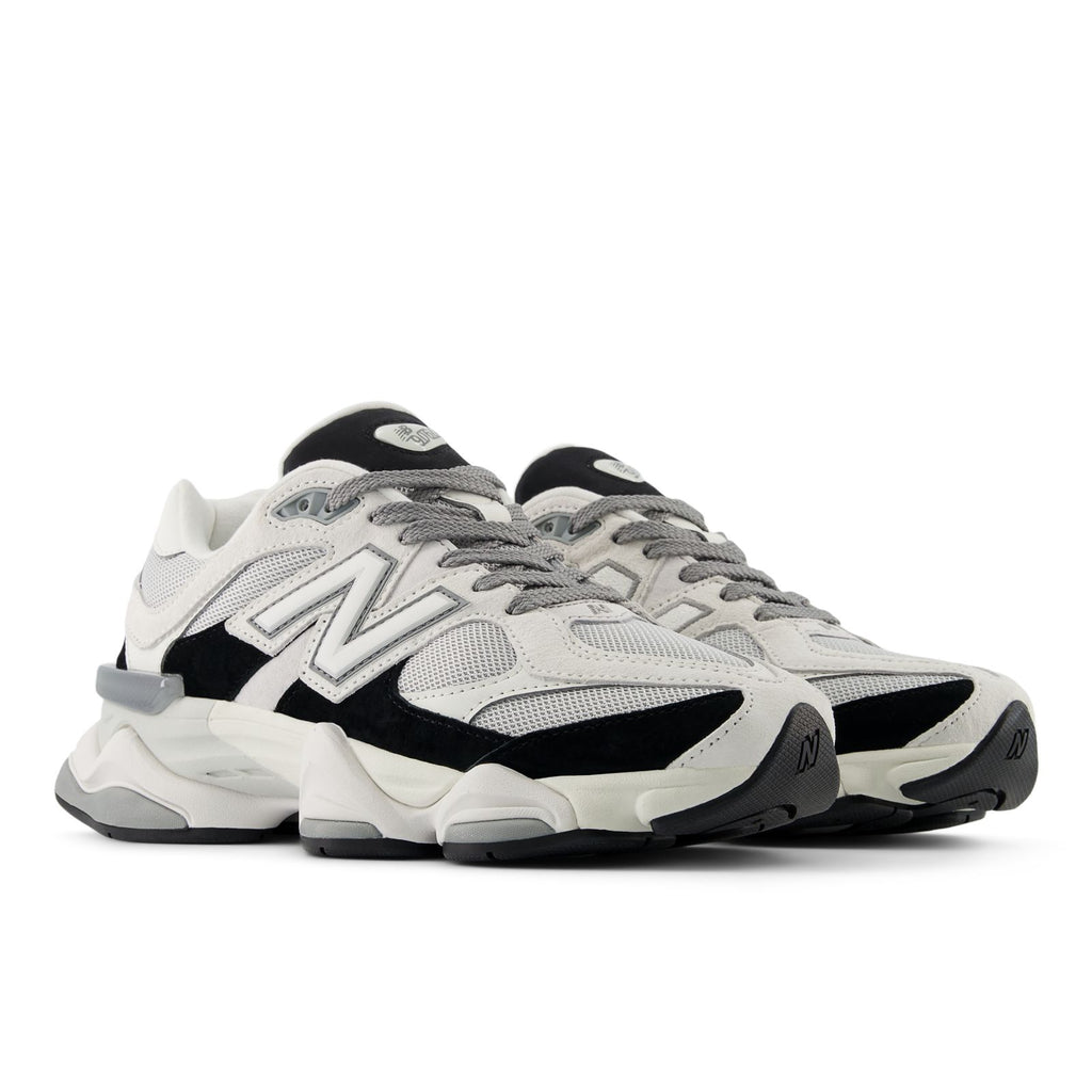 Unisex running shoes with gray mesh upper, black overlays, and white heel pull
