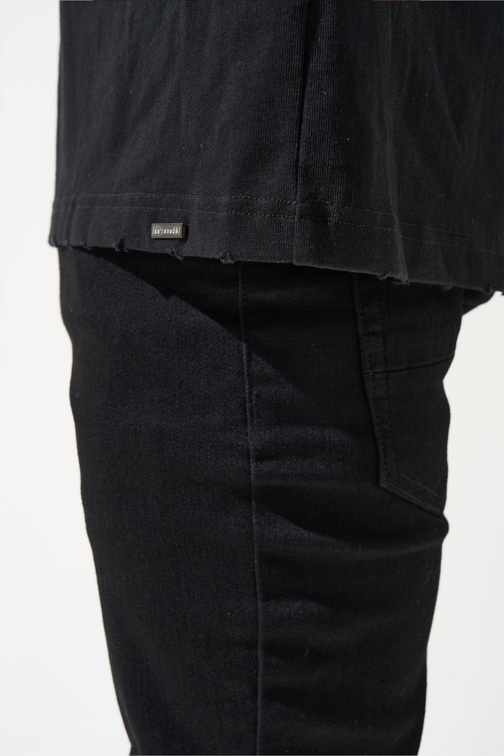 Men's dark jeans hem and pocket seam with folded over cuff detail