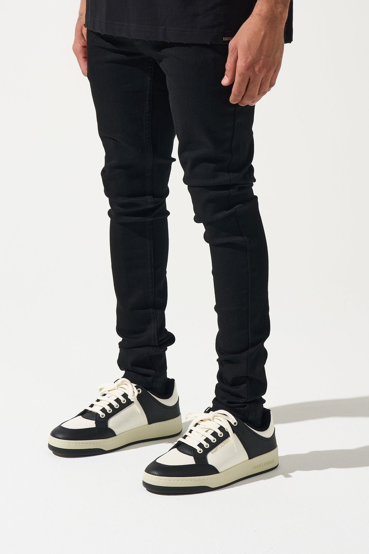 Men's dark jeans with five-pocket styling and slim tapered legs
